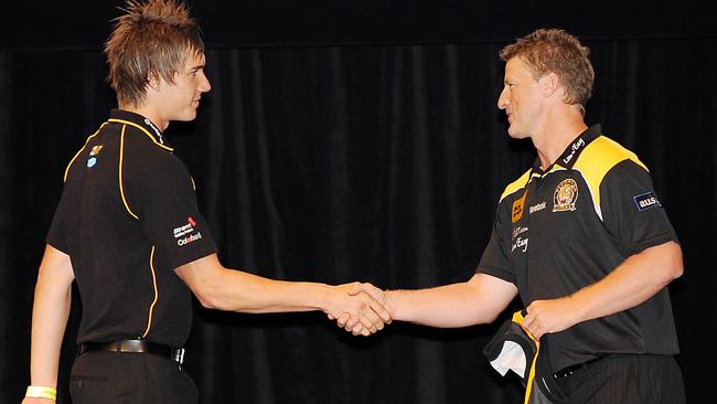 Martin accepts his guernsey from coach Damien Hardwick after being snapped up by the Tigers with Pick 3. Picture: George Salpigtidis