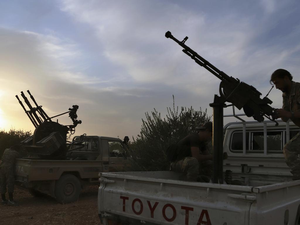 Turkey-backed Syrian opposition fighters prepare their guns in Syria's northern region of Manbij. Picture: AP