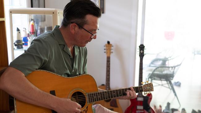 Breakfast radio host Stav Davidson playing his guitar at home in The Gap. Photograph: David Kelly.