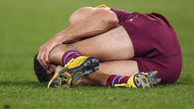 Charlie Cameron writhed in pain after hyperextending his knee. Picture: Getty Images