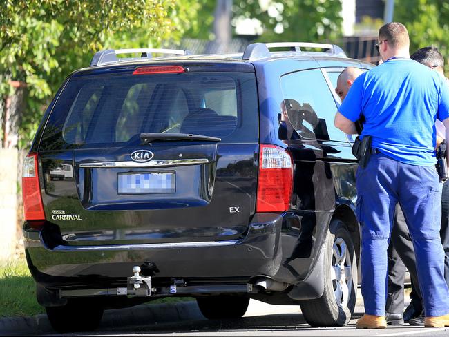 Police focus on a black Kia Carnival van. Picture: Mark Stewart