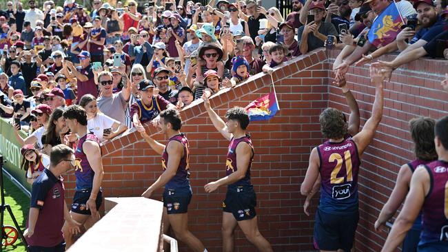 The crowd reach out to touch players during the last Lions open training session in Springfield, Brisbane. pic: Lyndon Mechielsen/Courier Mail