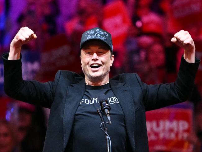 (FILES) Tesla and SpaceX CEO Elon Musk gestures as he steps on stage during a rally for former US President and Republican presidential candidate Donald Trump at Madison Square Garden in New York, October 27, 2024. Billionaire Elon Musk was expected in court in Philadelphia on October 31, 2024, after a judge ordered him to attend a hearing in a lawsuit seeking to halt his $1 million giveaways to registered US voters in swing states. (Photo by ANGELA WEISS / AFP)