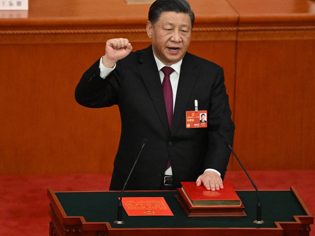 China's President Xi Jinping swears under oath after being re-elected as president for a third term during the third plenary session of the National People's Congress (NPC) at the Great Hall of the People in Beijing. Picture: AFP