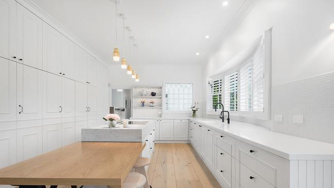 Wide American oak floors accentuate the designer kitchen.