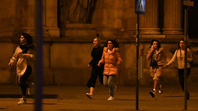 Women run from the scene of a shooting near a synagogue in central Viennaa. Picture: AFP