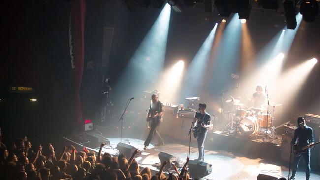 American rock group Eagles of Death Metal performing on stage on November 13, 2015 at the Bataclan concert hall in Paris, just a few moments before four men armed with assault rifles and shouting "Allahu akbar" ("God is great!") stormed into the venue and opened fire. Picture: AFP / Marion Ruszniewski