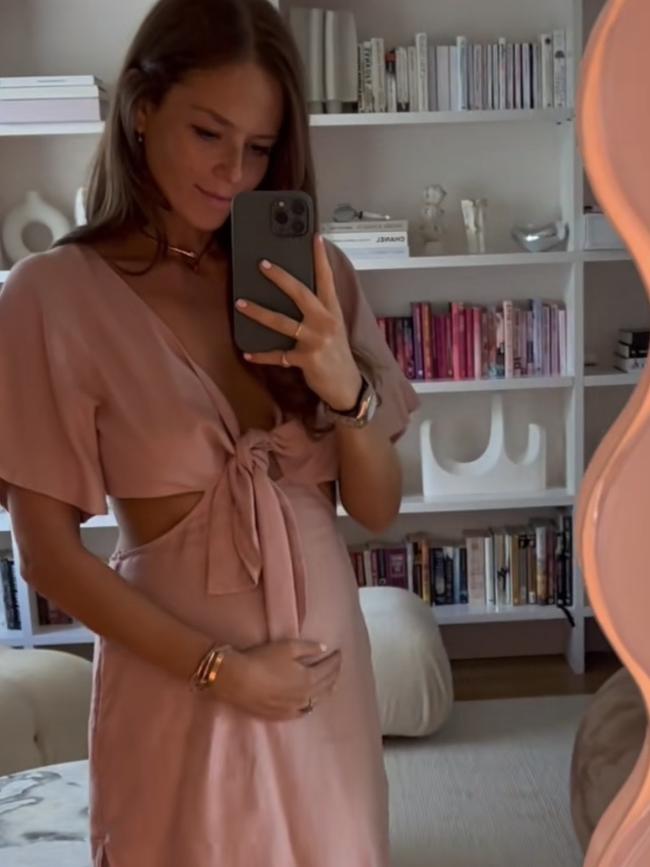 Georgia Danos holding her baby bump.