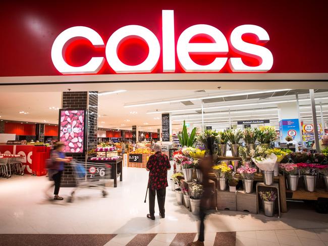 A shopper stands at the entrance to a Coles supermarket, operated by Wesfarmers Ltd., in Sydney, Australia, on Tuesday, Feb. 18, 2014. Wesfarmers, Australia's largest employer, is scheduled to report first-half earnings on Feb. 19. Photographer: Ian Waldie/Bloomberg via Getty Images