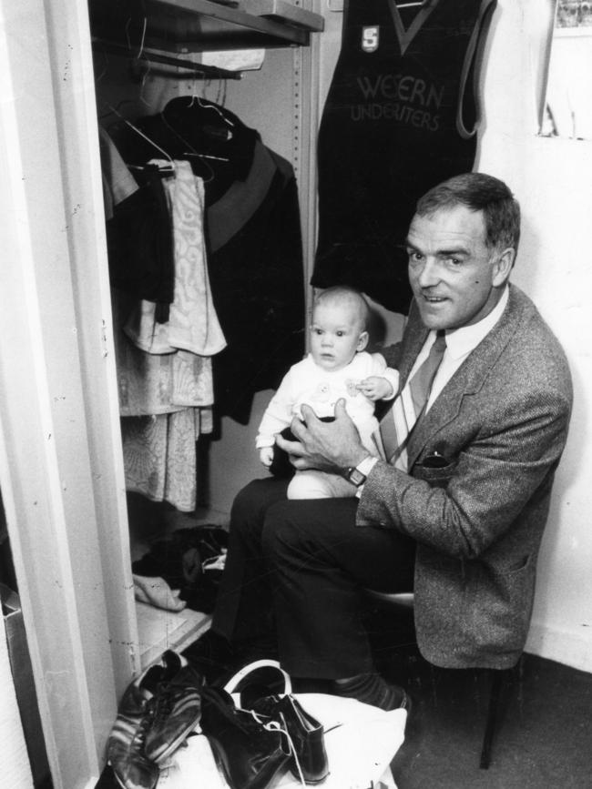 Coach Neil Kerley with grandson Nathan cleaning out his locker at Richmond Oval before coaching West Adelaide for the last time.