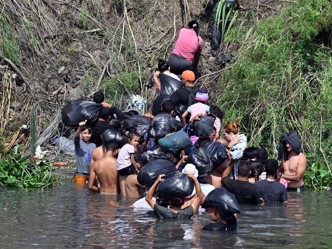 Migrant people try to get to the US through the Rio Grande, which is reinforced with a barbed-wire fence, as seen from Matamoros, state of Tamaulipas, Mexico on May 10, 2023. Picture: AFP