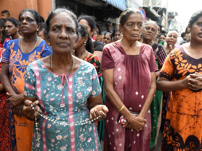 Sri Lankan mourners take part in moments of silence in tribute to bomb blast victims in Colombo.