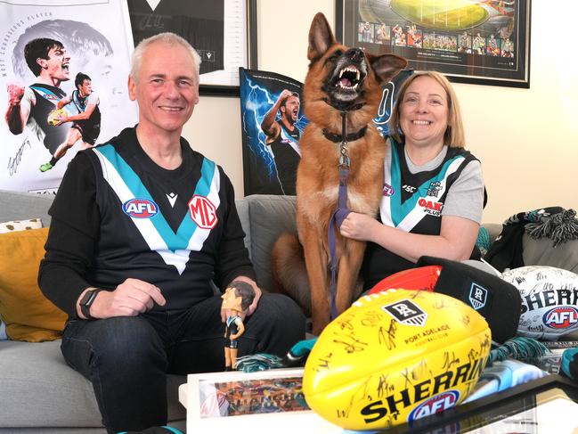 Port Fans Karin and Gary Cullen, booked their flights to Sydney during half time at the Port v Hawthorn game to secure a seat to make it to the Port v Sydney game next week. Jax the German Shepherd wonÃt be going, but is happy to give his best Zac Butters impersonation. 15 September 2024. Picture: Dean Martin