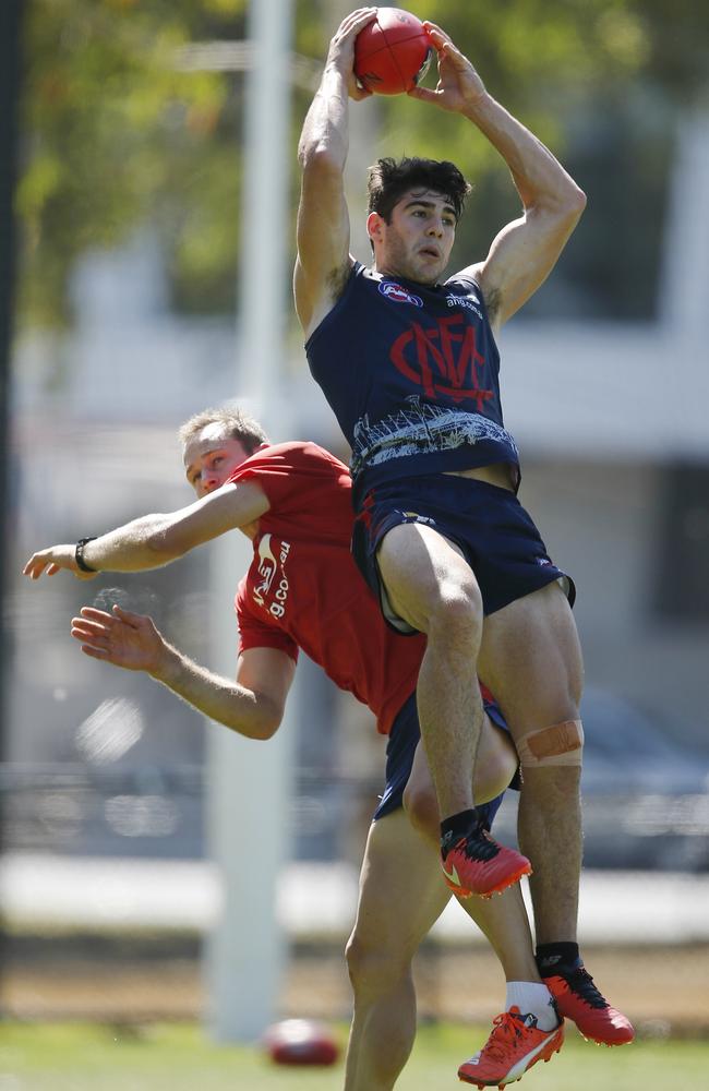 Christian Petracca marks over Daniel Cross. Picture: Michael Klein