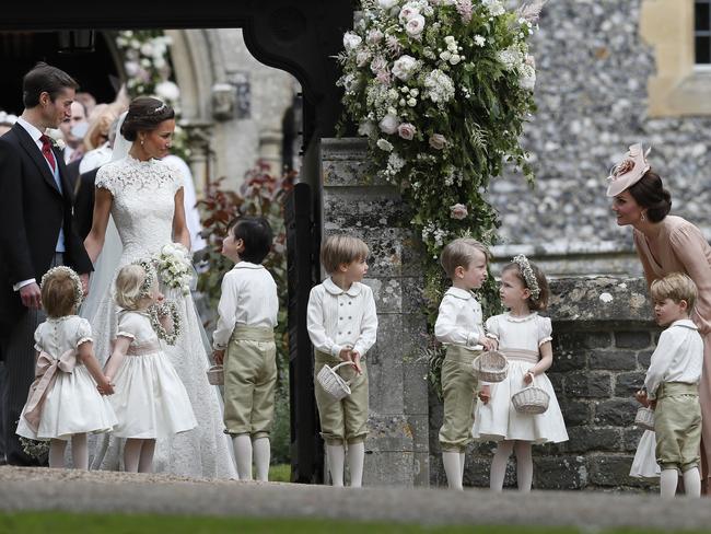 Kate plays with the children as her sister and brother-in-law watch on.