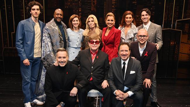 Sir Elton (centre) poses with supporters including David Furnish (left) and Donatella Versace (back), as well as lead actress Vanessa Williams (red). Picture: Getty Images