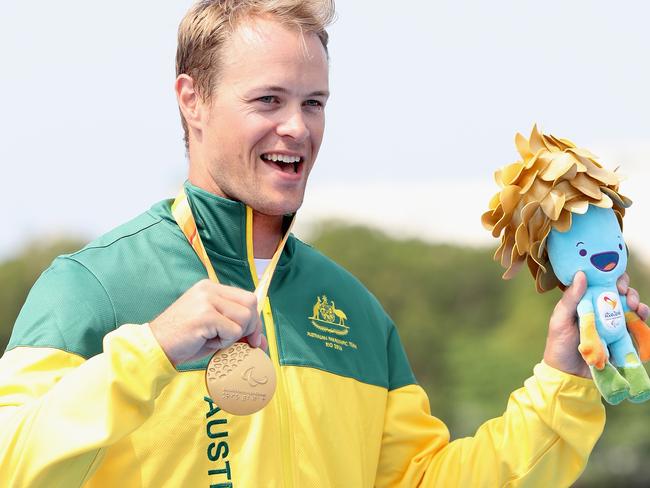 RIO DE JANEIRO, BRAZIL - SEPTEMBER 15: Curtis McGrath of Australia poses on the medals podium after winning the men's KL2 final at Lagoa Stadium during day 8 of the Rio 2016 Paralympic Games at the Olympic Stadium on September 15, 2016 in Rio de Janeiro, Brazil. (Photo by Matthew Stockman/Getty Images)