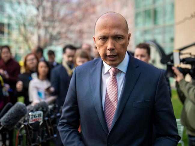 (FILES) A file photo taken on August 21, 2018 shows Australia's home affairs minister Peter Dutton leaving a press conference in Canberra. - Dutton is under mounting pressure on August 31, 2018 to formally explain why he personally intervened to help au pairs from France and Italy after their tourist visas were cancelled. (Photo by SEAN DAVEY / AFP)