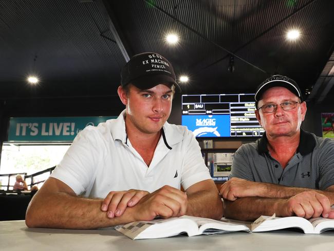 Trent Edmonds and Toby Edmonds check the sales guide at the Magic Millions complex at Bundall. Picture Glenn Hampson