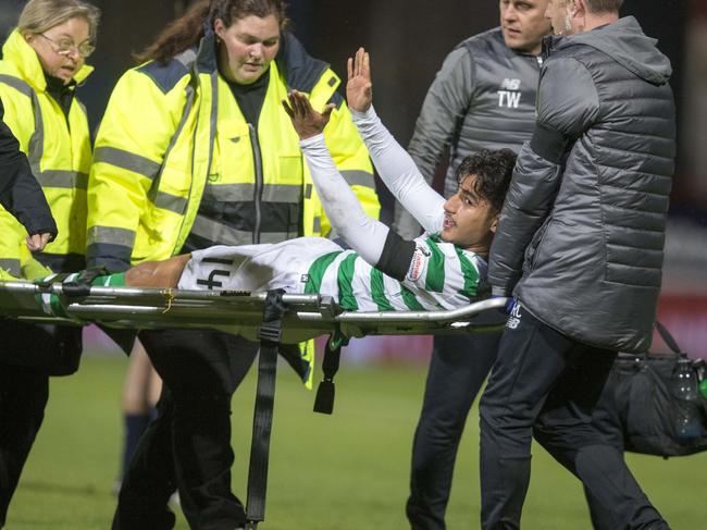 Daniel Arzani is stretchered off after he tore his ACL playing for Celtic against Dundee. Picture: PA