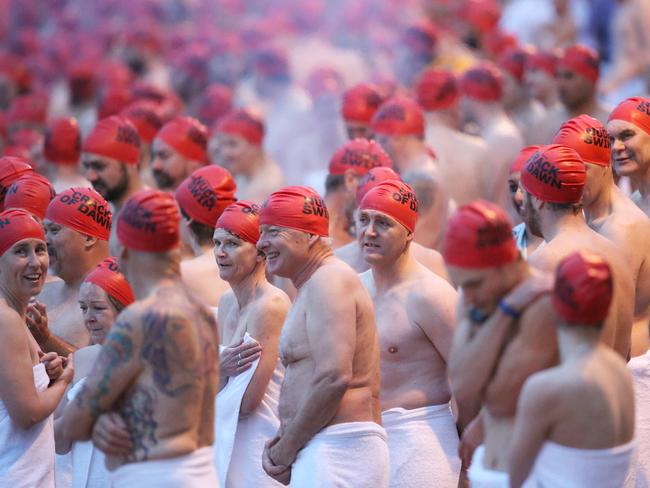 Swimmers keeping warm before the swim. Picture: NIKKI DAVIS-JONES