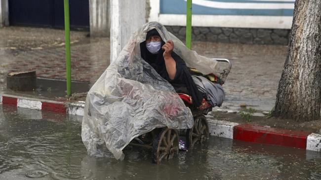 A woman waits to receive alms during Ramadan in Kabul. Picture: AP