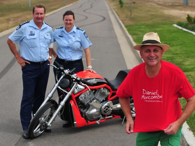 Inspector Russell Rhodes and Senior Sergeant Kylee Hayden with Townsville identity Steve Price and a Harley Davidson motorbike to be raffled at a Dance for Daniel function.