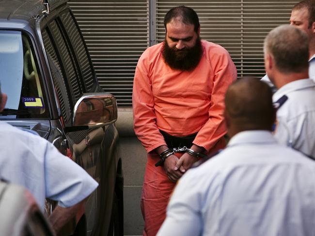 Belal Saadallah Khazaal arrives in handcuffs at the NSW Supreme Court at King Street, Sydney for his sentencing hearing for his producing of a book knowing it could assist a terrorist act.