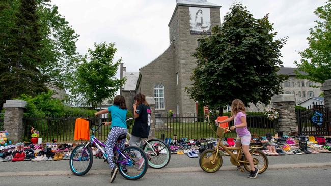 A makeshift memorial to the children who never came home, made up of hundreds of pairs of shoes, at the Francis Xavier Church, in Quebec. Picture: AFP.