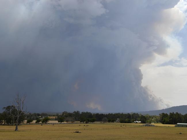 Smoke from bushfires rises high into the air as fires hit the area around the town of Nowra in the Australian state of New South Wales on December 31, 2019. - Thousands of holidaymakers and locals were forced to flee to beaches in fire-ravaged southeast Australia on December 31, as blazes ripped through popular tourist areas leaving no escape by land. Picture: Saeed Khan/AFP