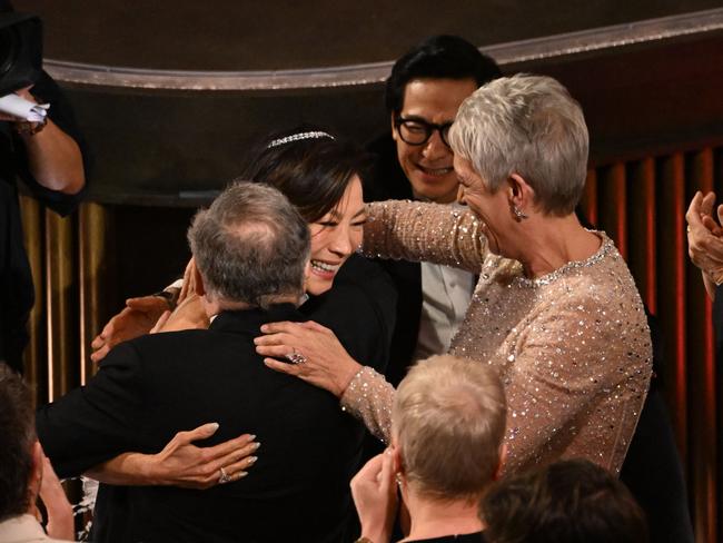 Malaysian actress Michelle Yeoh celebrates winning the Oscar for Best Actress with her co-stars. Picture: AFP