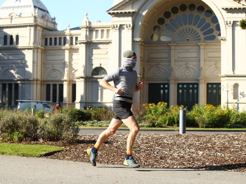 A man runs through the Carlton Gardens in Melbourne yesterday. Picture: Robert Cianflone