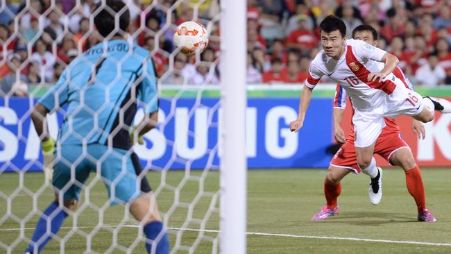 Sun Ke puts his second goal away for China.