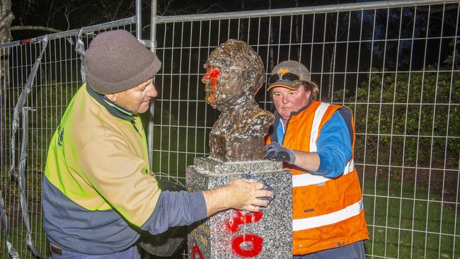 Council workers clean up a defaced statue of John Howard in Victoria. Picture:Rob Leeson.