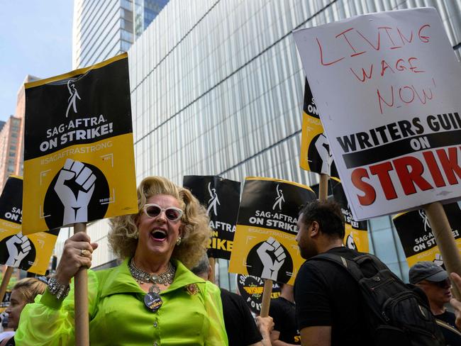 (FILES) Actors, writers and other union members join SAG-AFTRA and WGA strikers on a picket line  in front of the offices of HBO and Amazon, during the National Union Solidarity Day in New York City on August 22, 2023. Professional hairdressers and makeup artists work in the shadows of celebrities to make them sparkle on sets, red carpets and magazine covers. But from New York to Los Angeles, the historic strike of American screenwriters and actors is leaving the workers responsible for making up the stars with blank appointment books and empty savings accounts. (Photo by ANGELA WEISS / AFP)