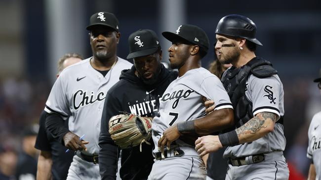 Tim Anderson is restrained by teammates. (Photo by Ron Schwane/Getty Images)