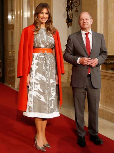 JULY 8: The First Lady teamed a bright Bottega Veneta cashmere coat with a silk Jill Sander dress in Hamburg, Germany, where she was greeted by First Mayor Olaf Scholz. Picture: Getty