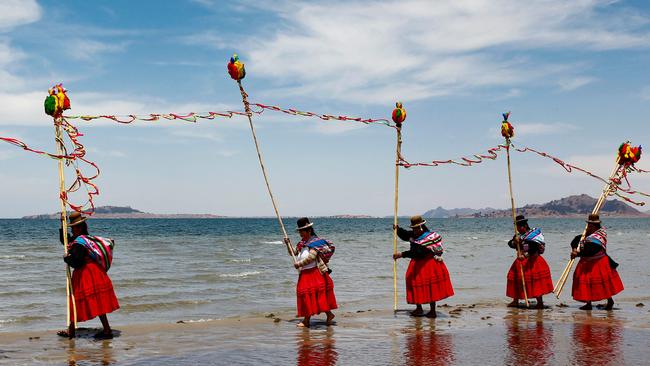 Aymara peasants make offerings on the shore of Lake Titicaca in Peru, with the intention to please the spirits and end the drought that has caused abnormally-low water levels. Picture: Juan Carlos Cisneros/AFP