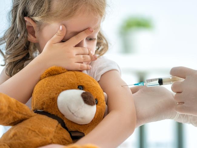 A doctor making a vaccination to a child