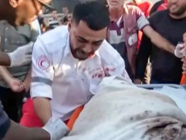 The moment medic Abed Bardini realised that he was transporting the body of his mother. Credit: Abed Al Kareem Hana/AP