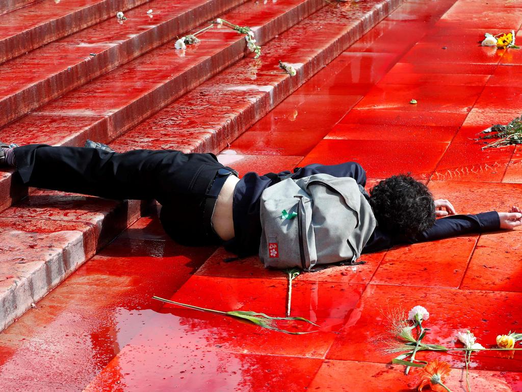 A member of Extinction Rebellion lies on the ground in fake blood on the Trocadero esplanade in Paris. Picture: Francois Guillot/AFP