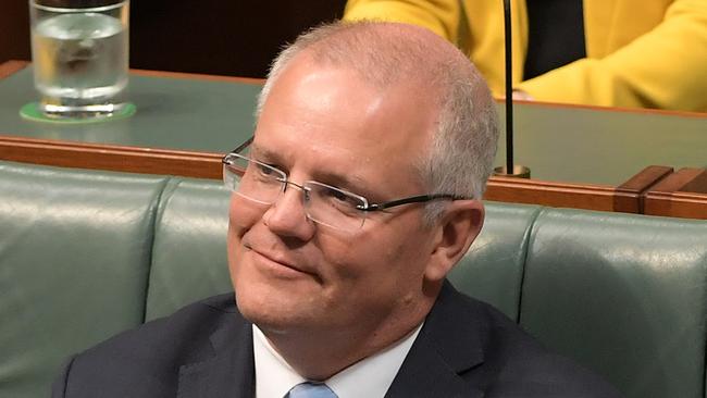 Prime Minister Scott Morrison listens to Treasurer Josh Frydenberg deliver the Budget in the House of Representatives. Picture: Getty