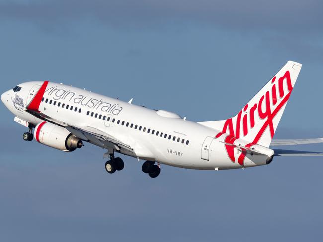 "Sydney, NSW, Australia - December 12, 2012: Virgin Australia plane with stairs waiting for passengers to board at Sydney Airport"