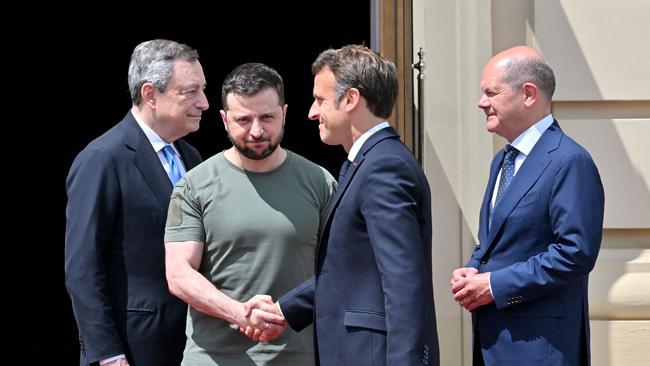 Emmanuel Macron shakes hands with Ukrainian President Volodymyr Zelensky, flanked by Prime minister of Italy Mario Draghi (L) and Chancellor of Germany Olaf Scholz (R). Picture: AFP