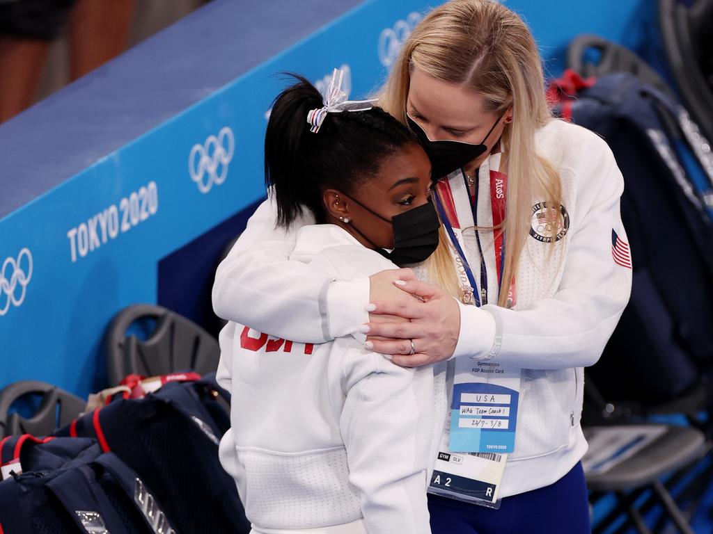 Simone Biles of Team United States is embraced by coach Cecile Landi during the Women's Team Final on day four of the Tokyo 2020 Olympic Games.