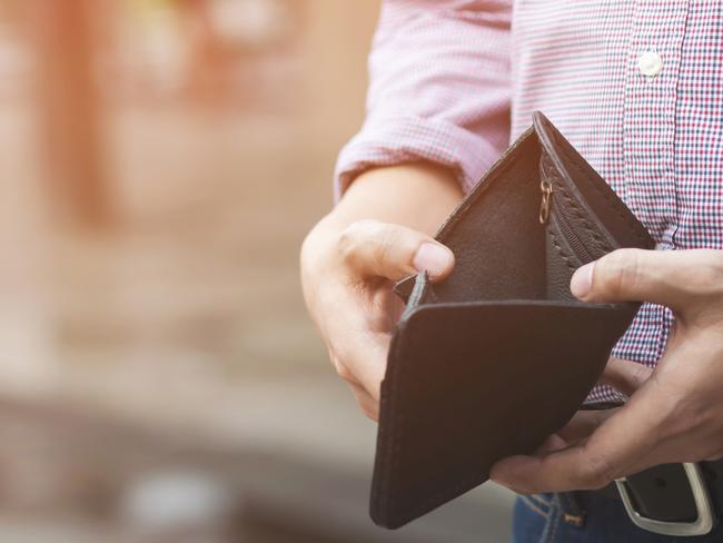 Empty wallet (no money) in the hands of an businessman. High cost of living in city Cost control expenses poverty in concept.