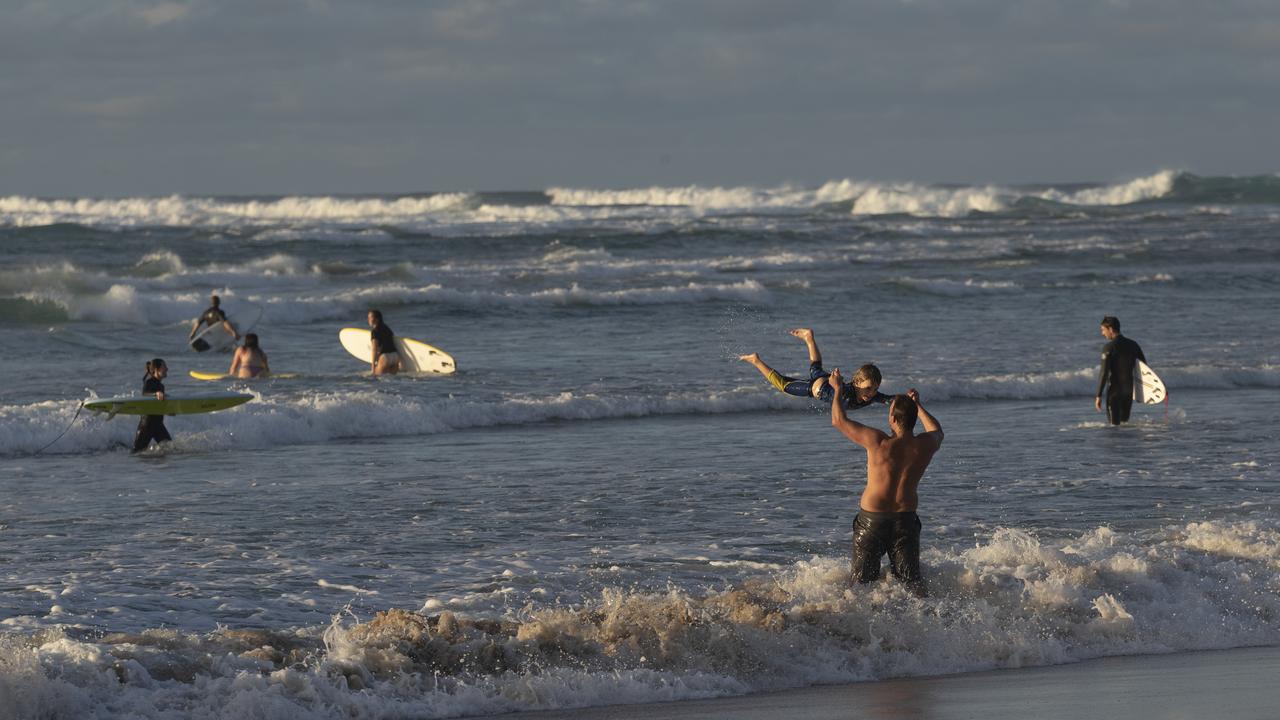 Surfers at Wategos Beach at Byron Bay earlier this month as domestic tourists started to return after COVID-19 travel restrictions eased. Picture: Brook Mitchell/Getty