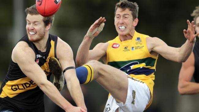 Glenelg’s Christian Howard tries to smother a kick by Phillip Raymond of the Eagles. Picture: Matt Turner.