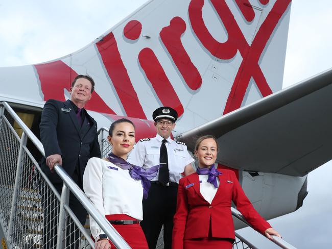 10/3/21: L to R..Nico Porter(CS), Bianca Yates, Captain Paul Anderson and Delia Taylor at Sydney airport. Virgin Australia crew are set to benefit from a suite of assistance measures being rolled out by the federal government to help airlines and the tourism industry continue to recover. John Feder/The Australian.