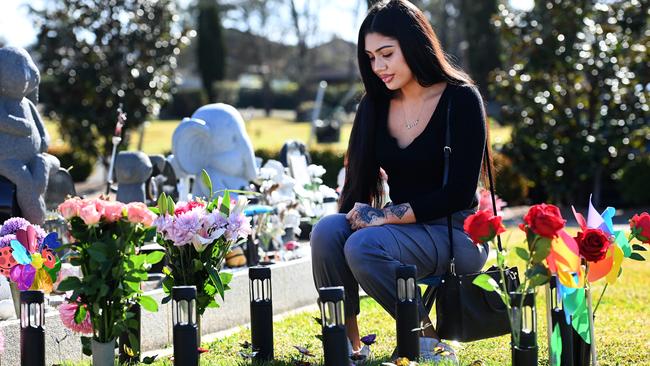 Leticia sits by the grave of her unborn daughter, who she named Adeya. Picture: Jeremy Piper